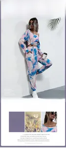 Detail of tie-dye lounge set featuring asymmetric off-shoulder top and drawstring hem