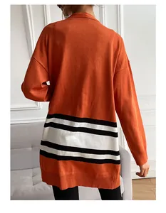 Back view of a long-sleeve orange knit cardigan with black and white stripes on the hem