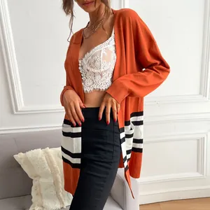 Women's orange knit cardigan with contrast black and white striped pockets and open front
