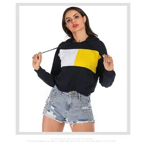 Detail view of contrast color block hoodie with yellow and white panels on dark blue