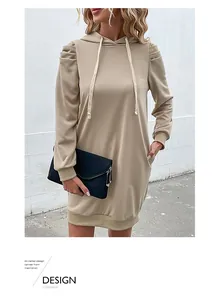 Detail of khaki hooded sweatshirt dress showing puff shoulders and ribbed cuffs texture