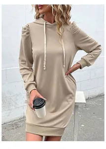 Detail of elegant puff sleeves and ribbed cuffs on an apricot hooded sweatshirt dress