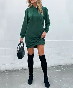 Detail of dark green hooded sweatshirt dress featuring ribbed cuffs and drawstring hood