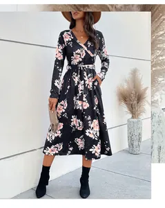Detail of V-neck floral midi dress featuring side pockets and a waist-tie bow