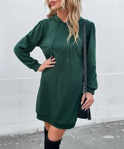 Close-up of a dark green hooded sweatshirt dress featuring soft fabric and ribbed cuffs