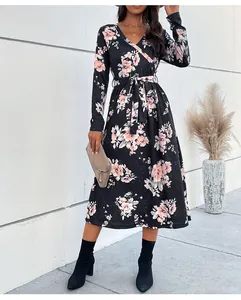 Detail of V-neck floral midi dress with waist tie and elegant long sleeves in black