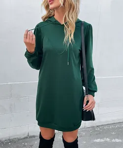 Detail of dark green hoodie dress featuring adjustable drawstrings and ribbed cuffs