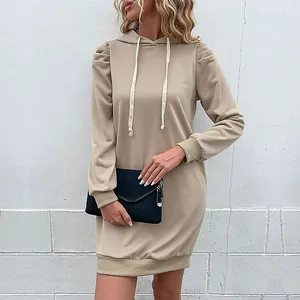 Women's khaki hoodie dress with puff sleeves and cream drawstrings in a casual midi style