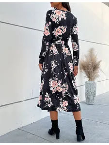 Back view of a long sleeve floral midi dress with black base and pink flowers