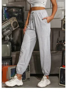 Women's high-waisted grey joggers featuring elastic drawstring waist and cinched ankles