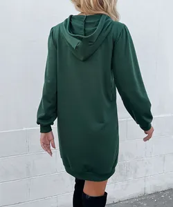 Back view of a long dark green oversized hoodie dress with ribbed cuffs and hem details