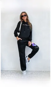 Close-up of black hoodie set featuring white letter print and gradient butterfly detail