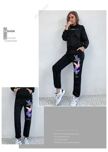 Detail of black hoodie and joggers set featuring colorful butterfly and letter prints