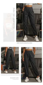 Detail of high waisted grey joggers featuring elastic drawstring waist and side pockets