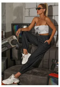 Detail view of high-waisted dark grey joggers with adjustable drawstring waistband