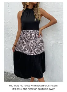 Detail of halter neck dress with leopard print patchwork and tiered pleated hem