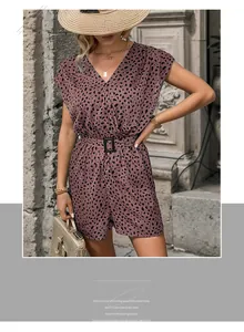 Detail view of pink leopard print jumpsuit featuring V-neckline and matching belt