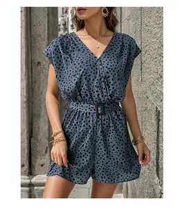 Detail of grey-blue leopard print romper with deep V-neck and black buckle belt