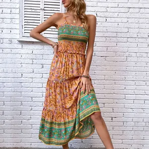 Bohemian floral maxi dress with smocked bodice and tiered skirt in orange and teal