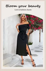 Detail of black off-the-shoulder midi dress with side slit and waist tie in a resort setting