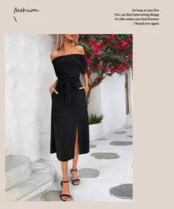 Detail of off-shoulder black midi dress with front slit and waist belt in street style