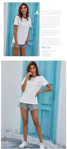 Detail of white cotton t-shirt featuring floral print and light blue denim shorts