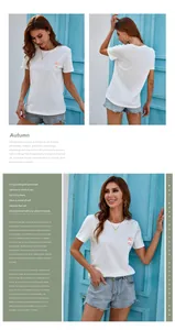 Detail of white cotton T-shirt featuring colorful floral embroidery and artistic lettering