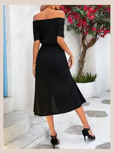 Detail view of a black off-shoulder midi dress featuring side slit and elegant short sleeves