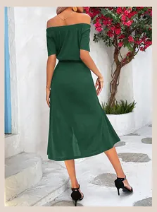 Rear view of an elegant off-shoulder dark green midi dress with a high side slit detail
