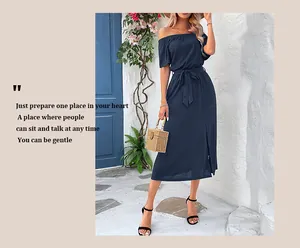Detail of navy blue off-shoulder dress featuring a waist tie and elegant side slit