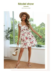 Detail of square neck floral dress featuring flutter sleeves and red rose prints