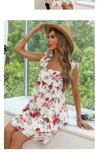 Detail of white floral dress featuring red rose print and ruffled strap square neckline