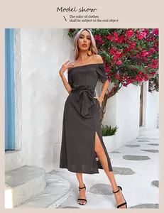 Detail of waist tie and side slit on an off-shoulder summer dress in dark grey