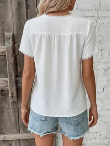 Detail of white summer shirt with lace trim and back pleats paired with denim shorts