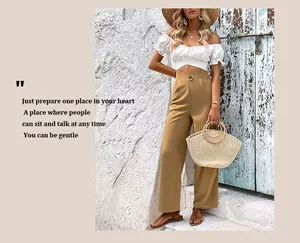Detail of high-waist straight-leg trousers with elegant round buckle and pleats