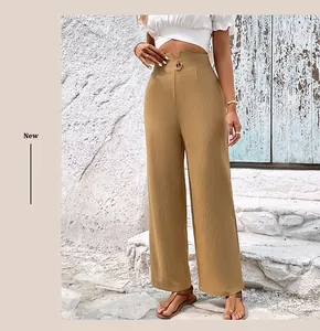 Detail of high-waisted khaki straight trousers with V-cut waist design and cotton linen texture