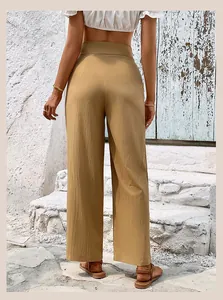 Detailed back view of khaki high waisted wide leg trousers with textured fabric finish