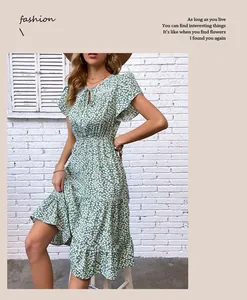 Detail of light green floral dress with lace neckline and elastic high waist
