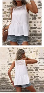 Detail of white sleeveless top showing lace patchwork and ruffled peplum hem