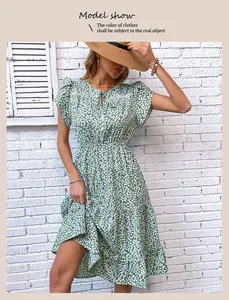 Detail of floral summer dress featuring tiered ruffle skirt and elastic waist in green