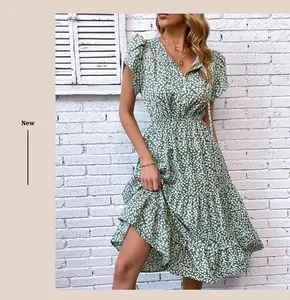 Detail of green floral dress featuring V-neckline, flutter sleeves and ruffle hem texture