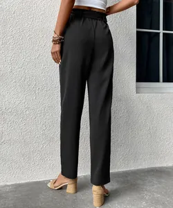 Detail view of high waisted black trousers featuring elastic drawstring waist and textured fabric
