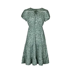 Detail of floral V-neck dress with white lace trim and drawstring on dark green fabric