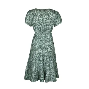 Detail view of the back of a dark green floral dress with high waist and tiered ruffle hem