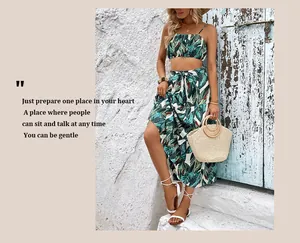 Detail of tropical palm print two-piece set featuring lace-up side slit maxi skirt