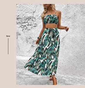 Detail of tropical leaf print two-piece set featuring high-waisted skirt and tie waist