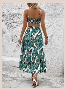 Detail of tropical leaf print on two-piece summer set with backless crop top and tiered skirt