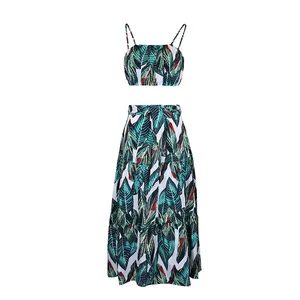 Detail of tropical plant print on women's two-piece summer crop top and tiered maxi skirt