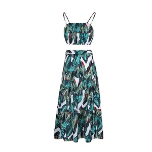 Detail of tropical palm leaf print on a two-piece summer set with thin straps and a long skirt