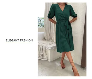 Detail of elegant dark green V-neck pleated dress with puff sleeves and waist tie